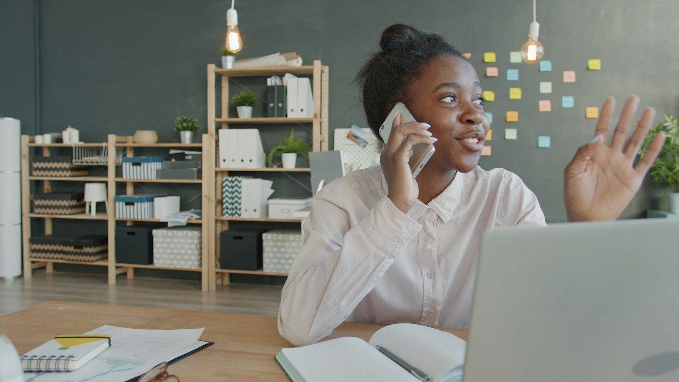 A woman on a business call at her desk